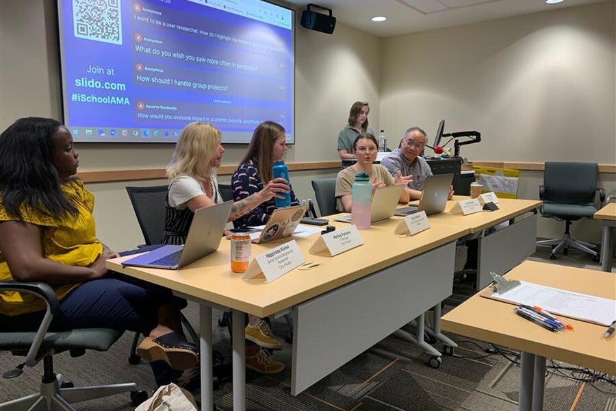 Alumni panelists sharing career advice during an iSchool event.