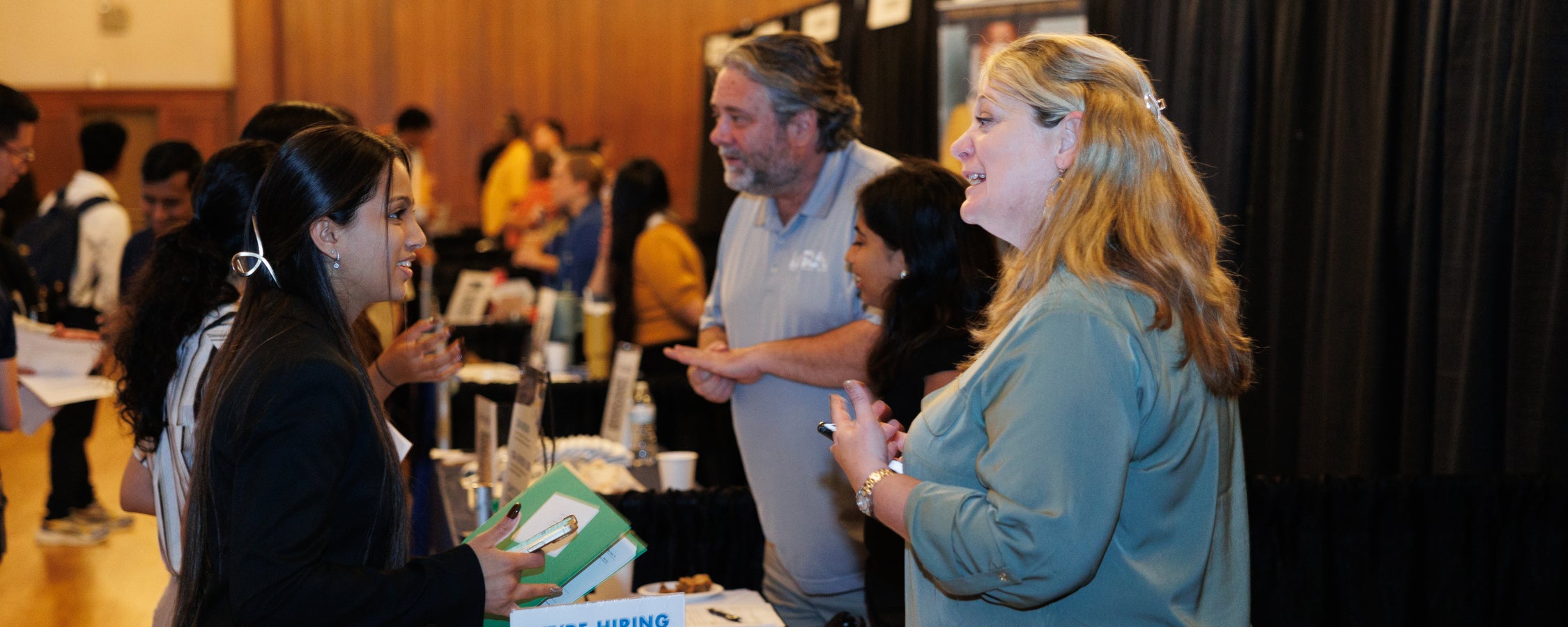 Students and employers in conversation at an iSchool career event.