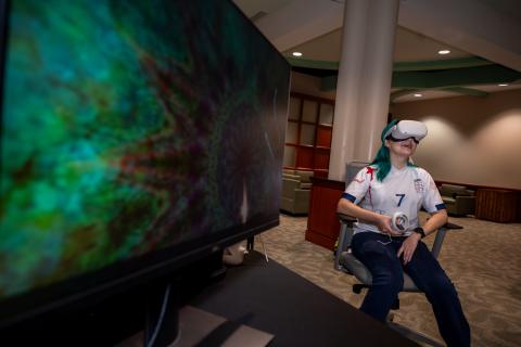 Person in chair with VR goggles on