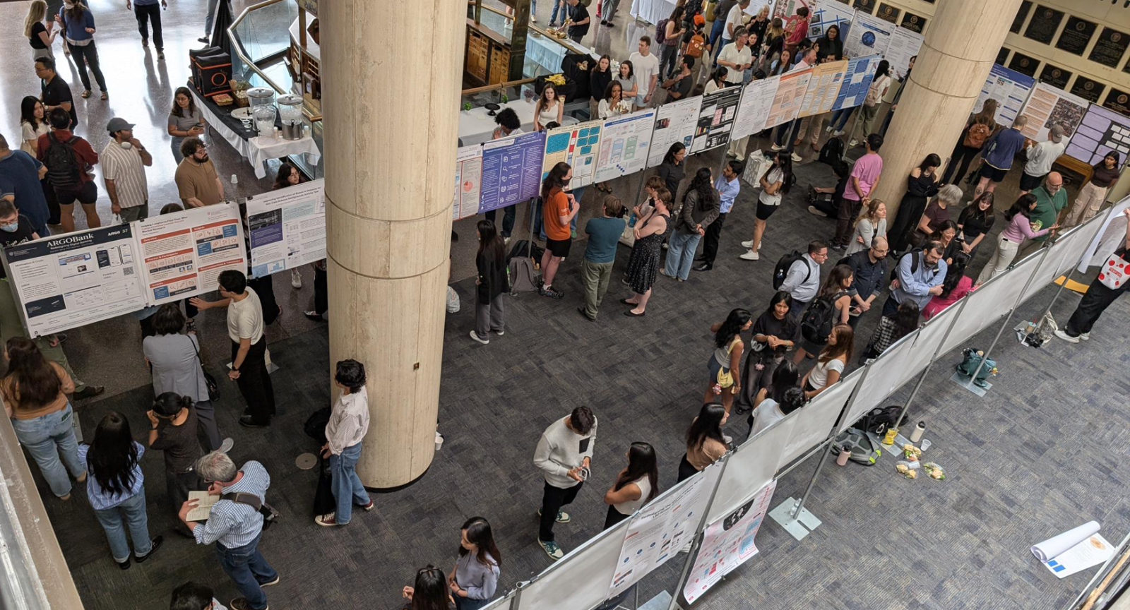 Guests viewing student posters at a previous iSchool capstone showcase.