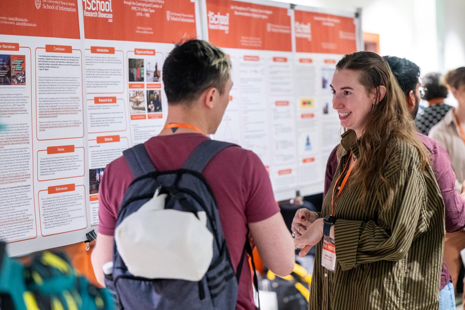 iSchool students talking in front of posters