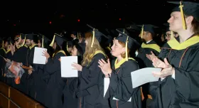 2025 graduates clapping at the end of the iSchool ceremony