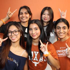 iSchool orientation flyer image of 5 students showing hook 'em horns