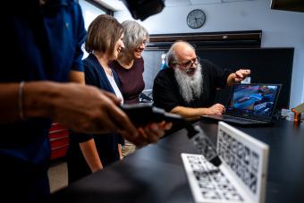 Researchers looking at screen showing a virtual welding simulator