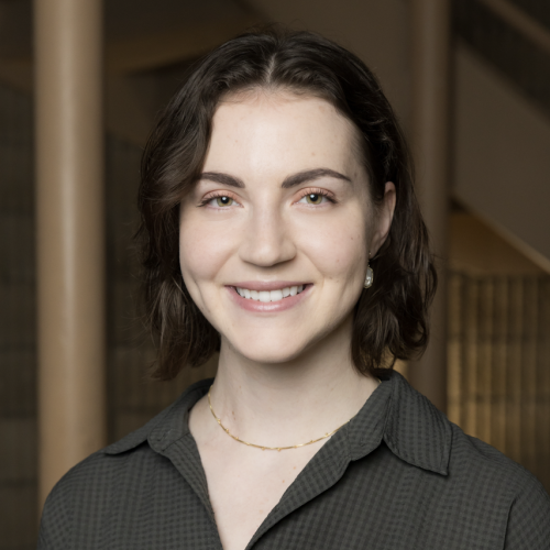 Alex Guterbock smiling in front of neutral background