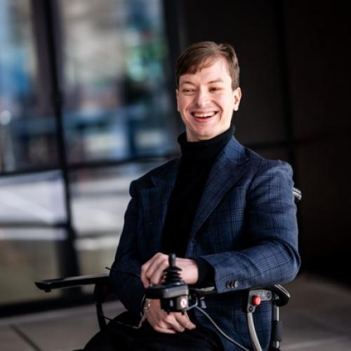 Jaxsen Day in wheelchair smiling