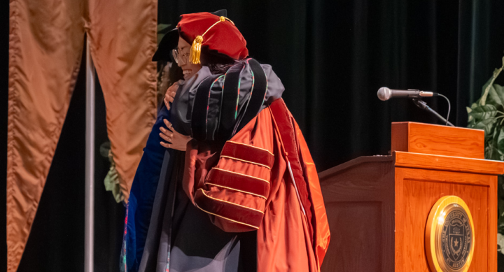 Min Kyung Lee and Angie Zhang embrace at commencement